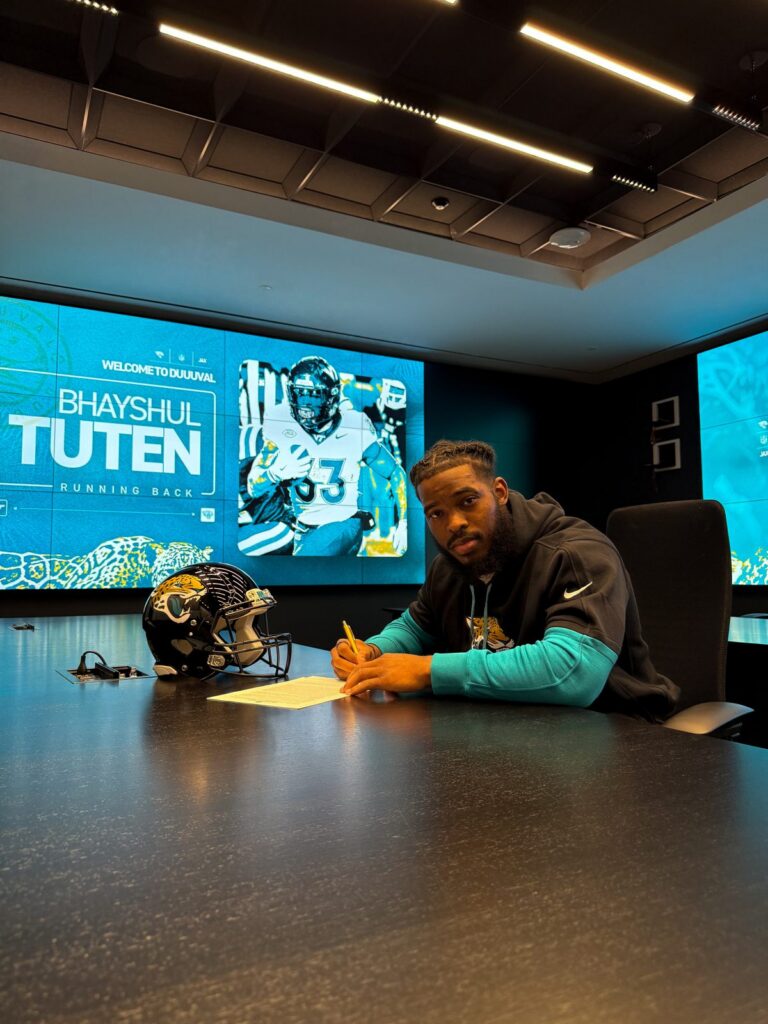 Bhayshul Tuten signs his contract with the Jacksonville Jaguars